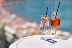 two glasses sitting on top of a table at Holiday Inn Express - Malta by IHG in St. Julianʼs +108 photos
