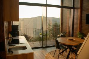 a kitchen with a table and a large window at Casa de Sobreiros in Amarante