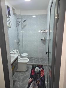 a bathroom with a shower and a toilet and a sink at Maggy Homes in Marimbeti