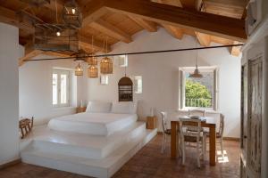 a bedroom with a white bed and a table at Castello di Granarola Relais - Adults Friendly - in Gradara +291 photos