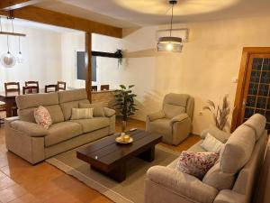 a living room with two couches and a coffee table at Casa Tío Tato , cerca de Puy du Fou y Toledo in Polán