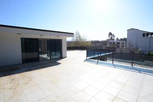 a large patio with a view of a building at Villa White Dolphin Kaprovani in Ureki