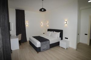 a bedroom with a bed and a desk and lights at Villa White Dolphin Kaprovani in Ureki +27 photos