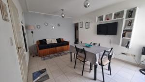 a living room with a table and chairs and a couch at Home in Río Cuarto