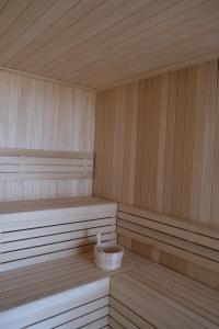 a wooden sauna with a tub in the middle at Hotel Club S'Illot in S'Illot