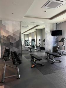a gym with several chairs and a large mirror at Saint Honore - La Casa De Khea in Sampong +4 photos