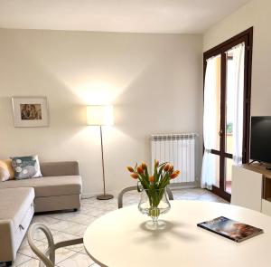 a living room with a table and a couch at Spacious, renovated apartment in the centre in Montecatini Terme