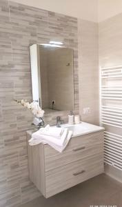 a bathroom with a sink and a mirror at Spacious, renovated apartment in the centre in Montecatini Terme +32 photos