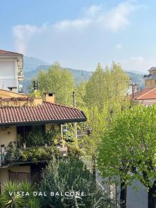 a view of a house with trees in the foreground at Spacious, renovated apartment in the centre in Montecatini Terme