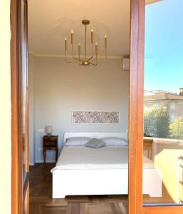 a bedroom with a bed and a chandelier at Spacious, renovated apartment in the centre in Montecatini Terme