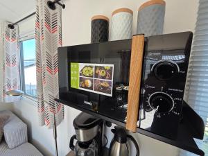 a television with a camera in a room at Moon Lodge in Koksijde