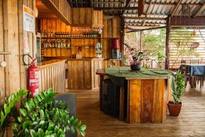 a kitchen with a table and a counter in a room at Vista do Lago Jungle Lodge in Cajual