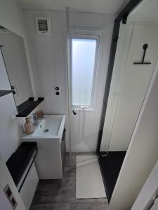 a bathroom with a sink and a window at Moon Lodge in Koksijde +21 photos