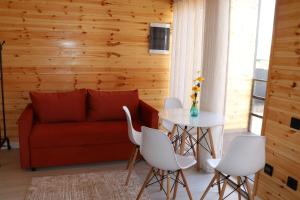 a living room with a couch and a table at Barn Peaks Karakol in Karakol