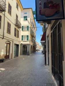 an empty street in a city with buildings at Chiara in Cairo Montenotte