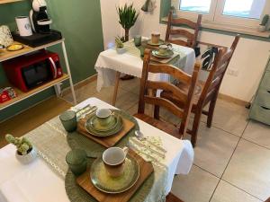 a living room with a table and chairs and a kitchen at FarAway House B&B in Narni +97 photos