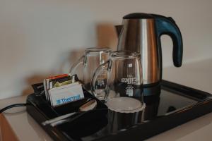 a coffee pot and glasses sitting on a stove at Hotel Thermal in Karlovy Vary