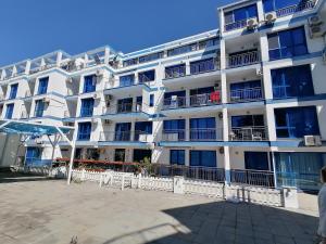 a large white building with a lot of windows at Студио C19 в к-с Blue Bay Palace in Pomorie