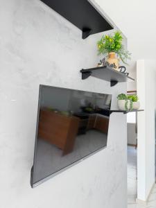 a living room with a large glass window on a wall at Casa Privativa Jacuzzi em Linhares in Linhares