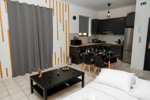 a living room with a couch and a kitchen at Ottoka in Kos +20 photos