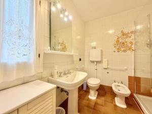 a bathroom with a sink and a toilet and a sink at VILLA MARE BLU in Levanto +73 photos