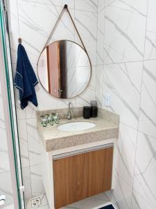 a bathroom with a sink and a mirror at Casa Privativa Jacuzzi em Linhares in Linhares +42 photos