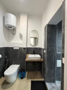 a bathroom with a toilet and a sink and a shower at Heart Of Bari in Bari