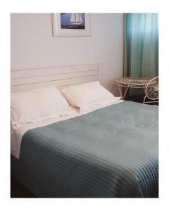 a bed in a room with a table at La Foresteria in Mola di Bari
