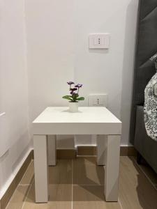 a white table with a plant on it in a room at Heart Of Bari in Bari +15 photos
