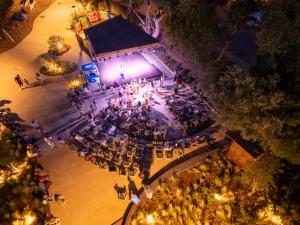an overhead view of a concert on a stage at night at Club del Sole Stella del Mare Family Collection in Castiglione della Pescaia +108 photos