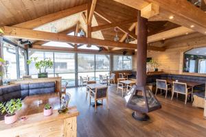 a large room with a wood stove in it at Le Konine - Hotel & Bar & Restaurant in Montceau-les-Mines