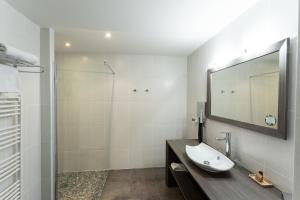 a bathroom with a sink and a shower at Le Konine - Hotel & Bar & Restaurant in Montceau-les-Mines +68 photos