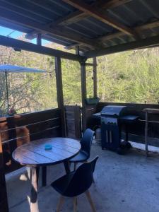 a table and chairs on a screened in porch at Cabane in Olivese