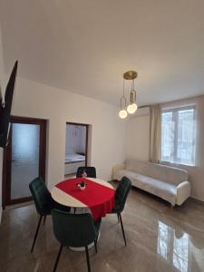 a room with a table and chairs and a bed at Fabian Apart CenterTown in Tulcea +29 photos