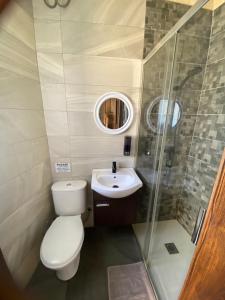 a small bathroom with a toilet and a sink at St Therese in Victoria