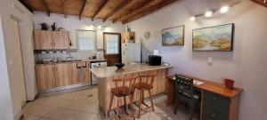 a kitchen with a island in the middle of a room at Clarents Cottage in Somerset West