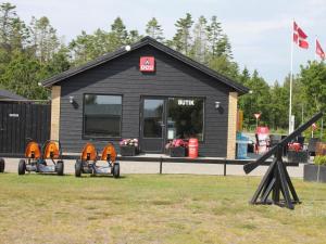 a black building with orange domes in front of it at DCU-Camping Ålbæk Strand in Ålbæk