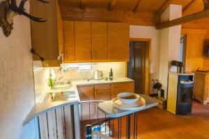 a kitchen with a counter with a bowl on it at Romantisches Berg-Chalet in Bayrischzell +6 photos
