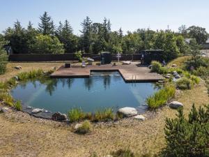 a pond in the middle of a garden at DCU-Camping Ålbæk Strand in Ålbæk