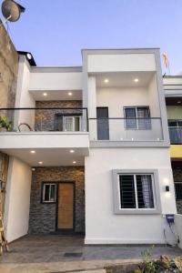 a white house with a balcony at Todkars Villa in Kolhapur