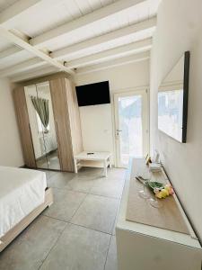 a bedroom with a bed and a table with a mirror at Giardini B&B in Modena