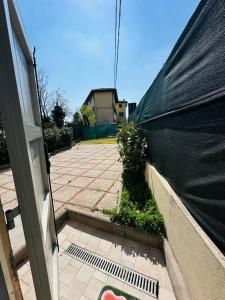 an outside view of a building with a black tarp at Giardini B&B in Modena