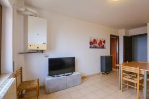 a living room with a flat screen tv and a table at Vista Mare in Sassonetto