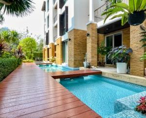 a swimming pool in the middle of a house at Vimanlay 84m style balinais - 2 chambres - plage, piscines in Cha Am +15 photos
