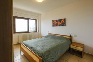 a bedroom with a bed and a window at Vista Mare in Sassonetto