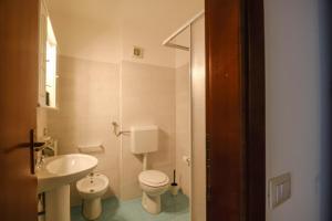 a bathroom with a white toilet and a sink at Vista Mare in Sassonetto