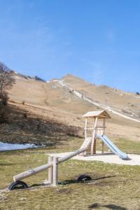 a wooden slide in a field with a hill at Vista Mare in Sassonetto +23 photos