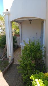 a patio with a table and a chair in a house at Appartement t2 terrasse, jardin in Cap d'Agde