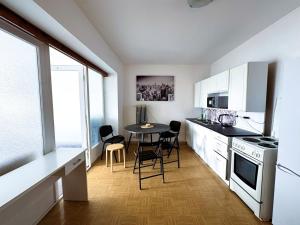 a kitchen with a table and chairs in a room at ROOMS Vystaviste BVV in Brno +59 photos
