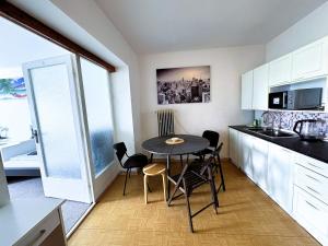 a kitchen with a table and chairs in a room at ROOMS Vystaviste BVV in Brno